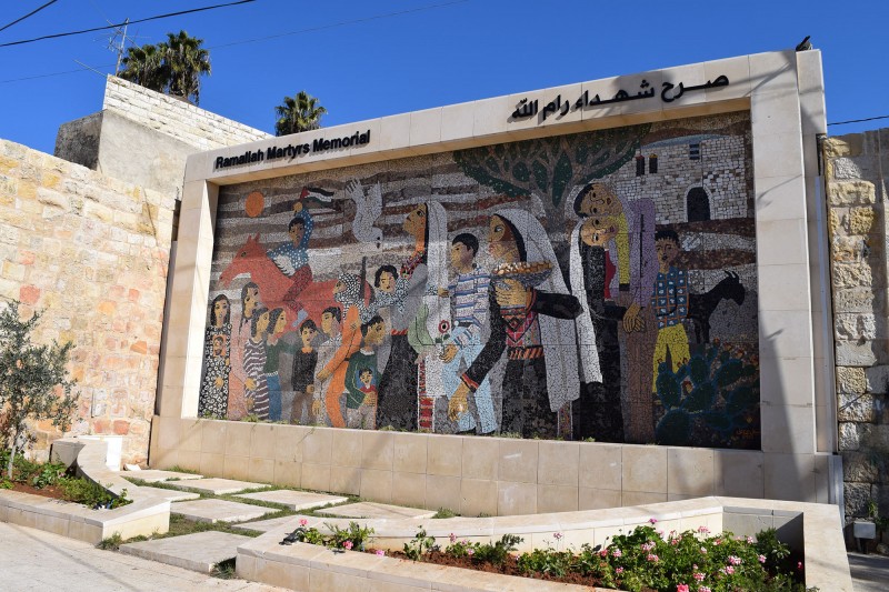 The richly coloured mosaic features images of the Sabra cactus, women and children holding pictures of martyred young men, olive trees, and a dove. 